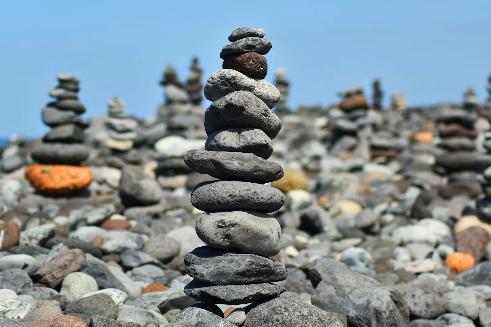 Stacked stone towers on a pebble beach on the Costa Adeje coast in Tenerife